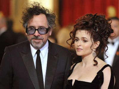 Tim Burton is on a suit and Helena Bonham Carter is wearing a black dress.